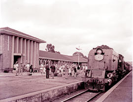 Nelspruit, 1960. SAR Class GMAM with main line passenger train in railway station.