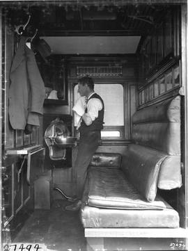 Interior of SAR Type C-16 passenger coupe with man shaving.