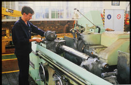 
Fitter and turner using a lathe in workshop.
