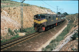 Germiston, 1981. Two SAR Class 6EI Srs 6's led by No E1647 with passenger train No 11down near Ro...