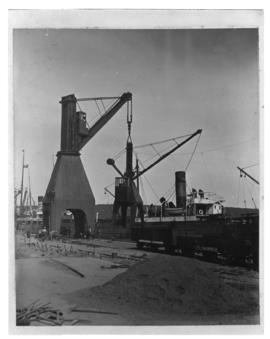 Durban, circa 1901. Harbour crane next to ship at quayside. (Durban Harbour album of CBP Lewis)