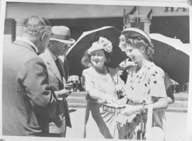 Queen Elizabeth smiles as Princess Elizabeth receives a gift.