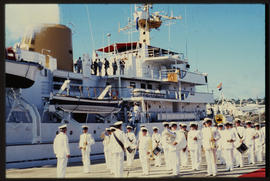Naval orchestra on wharf next ot ship.