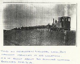 Orenstein & Koppel locomotive with goods wagons on embankment on an unknown civil site. About...