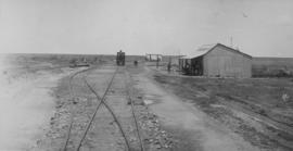 Madibogo, 1895. Cape 1st Class 1879 locomotive at store of S Solomon and Co looking south. (EH Sh...