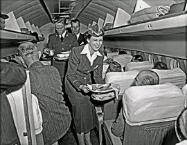 Johannesburg, 1950. Palmietfontein airport. SAA Lockheed Constellation Interior. Hostess serving ...