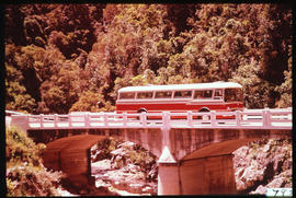 SAR Mercedes Benz tour bus on concrete bridge.