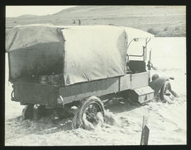 Delportshoop, circa 1915. Truck with milk cans fording the Vaal River at 'Berranges Bridge' durin...