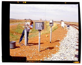 Bapsfontein, December 1982. Telephone technician working on equipment at Sentrarand. [T Robberts]