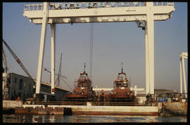 Ships under gantry crane.
