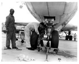 
Technicians working on Boeing 707 landing gear.
