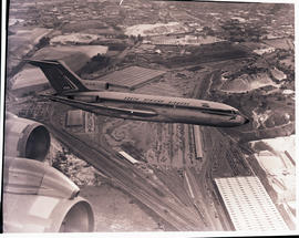 "Johannesburg 1966. SAA Boeing 727 ZS-DYN 'Limpopo' in flight over large railway yard."