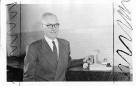 Mr JG Hay with model of new chairplate. SEE SARM December 1960.