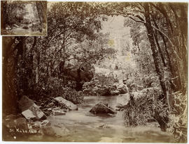 Stone pier in stream in dense bush. Caption 'Kilo 140'.