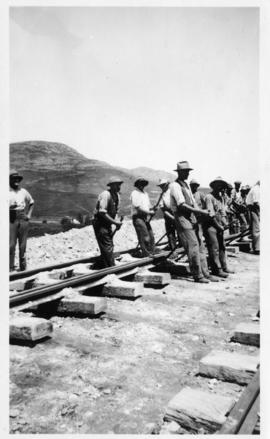 Team of workers lifting railway track with crowbars. SIMILAR TO P3030_31 (Lund collection)