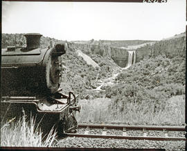 "Waterval-Boven, 1957. Elands River waterfall with partial view of locomotive."