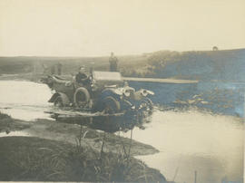 Motor vehicle in river.