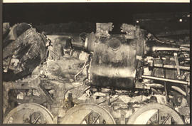 Close-up of damaged steam locomotive.