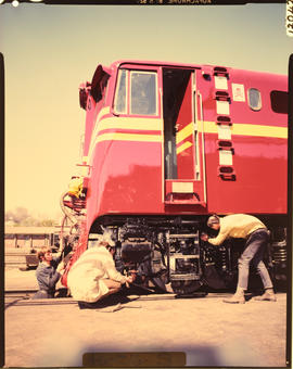 Pretoria, 1968. Fitters working on locomotive wheel at Koedoespoort.