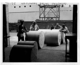 Durban, 1962. Reels of newspaper being unloaded in Durban Harbour.