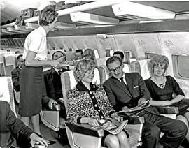 
SAA Boeing 707 hostess serving passengers.
