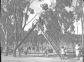 Children playing on slide in city park.