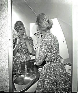 
SAA Boeing 707 ZS-CKC, woman refreshing her makeup.
