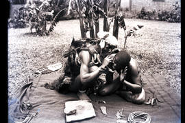 Natal. Zulu traditional healer examining patient.