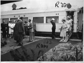 Queenstown, 6 March 1947. Royal family arrives at station, railway policeman saluting.