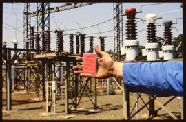SAR employee showing document at electrical substation.