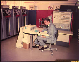 Statistician in mainframe computer room.