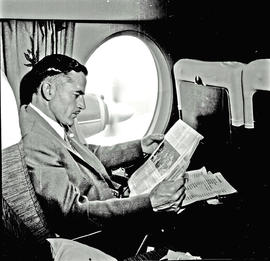 
SAA Vickers Viscount interior. Passenger reading. Note big oval window.
