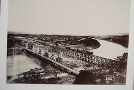 Circa 1901. Damaged bridge being repaired.