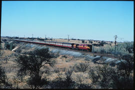 Fochville district, 1972. SAR Class 6E on Trans-Karoo passenger train on embankment.
