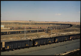 
Coal wagons waiting in open country.
