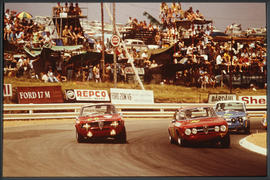 Motor cars racing on track.
