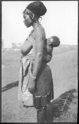 Circa 1925. Black woman in traditional dress with baby. (Album on Natal electrification)