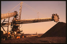 Port Elizabeth. The 'scooper' taking maganese ore from stockpile in Port Elizabeth Harbour.