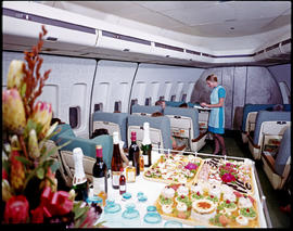 SAA Boeing 747 Interior. Food being served in first class. Hostess.