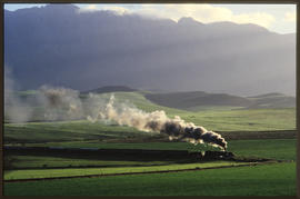 Steam locomotive with passenger train.