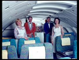 Cabin crew, hostess and steward, posing in First Class section of SAA Boeing 747.