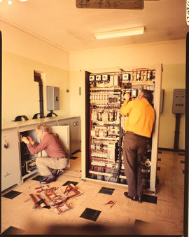 Electricians wiring electrical boxes.