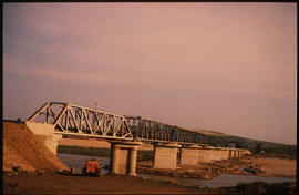 
Long steel truss bridge on concrete piers.
