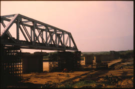 
Construction of long steel truss bridge on concrete piers.
