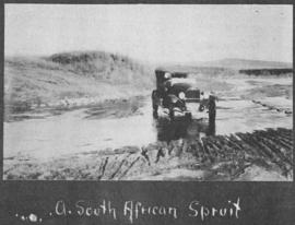 Circa 1925. Motor car in a small river. (Album on Natal electrification)