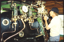 Driver inside steam loco cab.