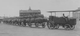 East London. Tractor with row of trailers stacked with 13 tonnes of wool.