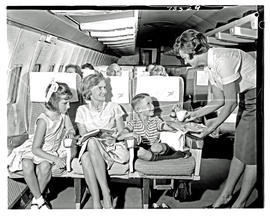
SAA Boeing 707 interior. Hostess, mother and young girl and boy.
