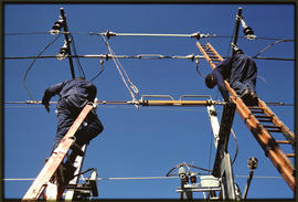 3kV DC overhead line equipment, traction linesmen adjusting a Siemens section insulator.