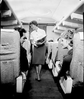 
SAA Boeing 707 interior. Magazines handed out by hostess and coffee served by steward.
